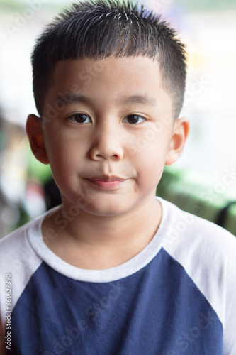 headshot of asian boy looking with eye contact to camera © stockphoto mania
