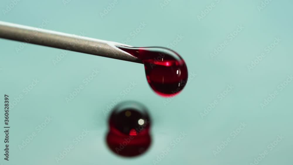 Blood like fluid coming from the tip of a syringe needle. Biotechnology, Vaccine and CRISPR concepts. Slow motion, Red Camera. Blood like fluid coming from the tip of a syringe needle. Biotechnology, Vaccine and CRISPR concepts. Slow motion, Red Camera.