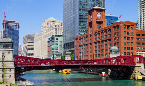 Landmark Chicago River with red steel bridge and boats, street and Chicago skyline with modern and classic architecture skyscrapes and office buildings photo