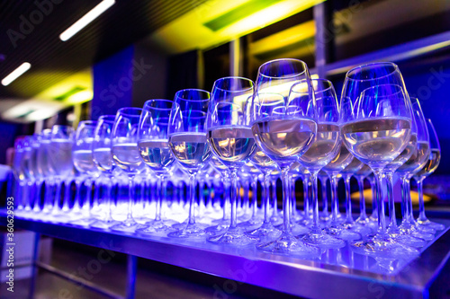 glasses of white wine in blue light