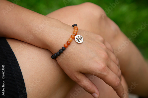 Fotografija Outboor closeup of hand wearing mineral stone bracelet