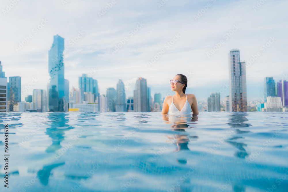 Fototapeta premium Portrait beautiful young asian woman relax happy smile leisure around outdoor swimming pool
