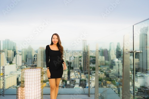 Portrait beautiful young asian woman at rooftop bar and restaurant