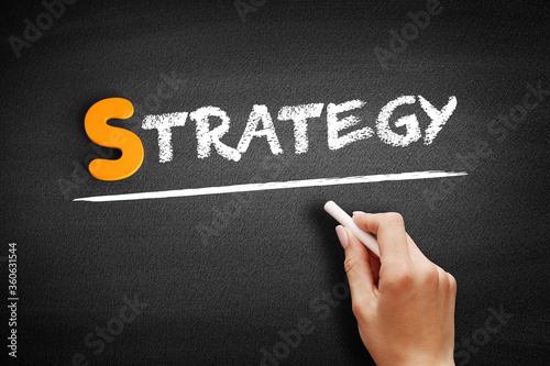 Strategy text on blackboard, business concept background