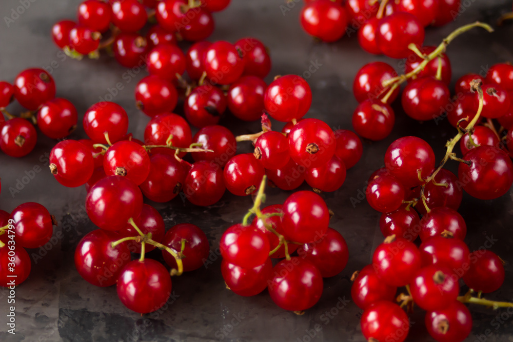 Red currants scattered over a gray texture background Red currants scattered over a gray texture background