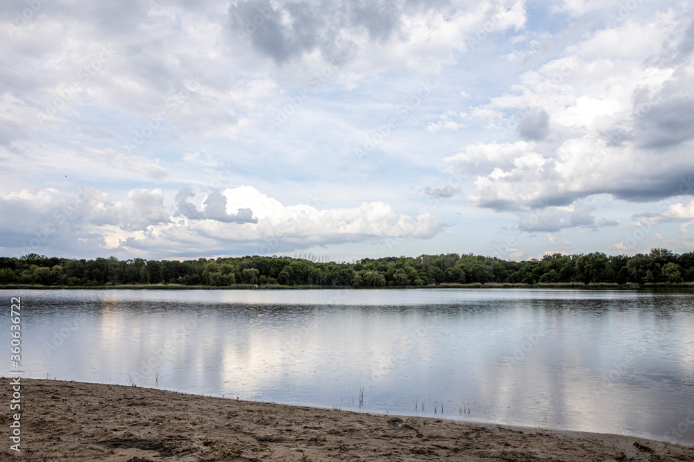 Beautiful clouds reflected on the blue lake surface