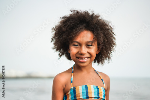 Portrait of african happy kid on the beach - Black ethnicity, real people, youth and happiness concept - Focus on child face