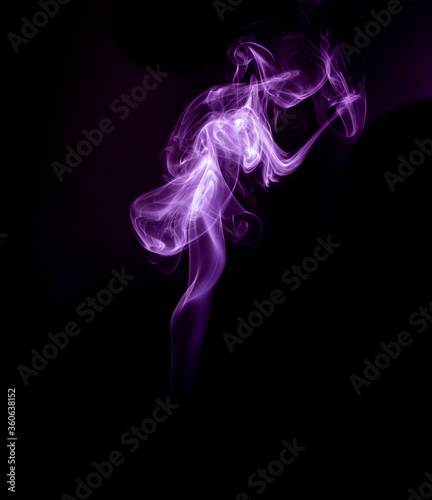 A realistic shot of a wisp of smoke against a black background - great for a cool background