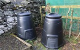 Two black compost bins in a winter vegetable garden in Wales.
