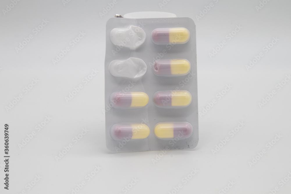 Medication in the form of capsules/pills/tablets against a white background Medication in the form of capsules/pills/tablets against a white background