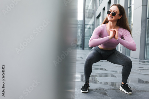 Fitness girl doing workout.  Girl doing squat exercises
