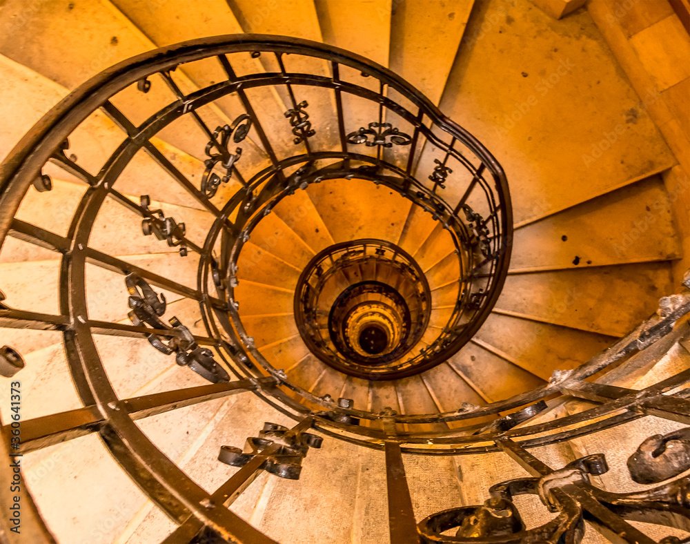 Fototapeta premium A view down a spiral staircase in Budapest in the summertime