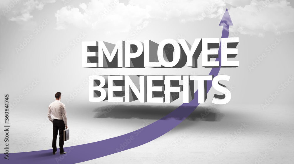 Rear view of a businessman standing in front of EMPLOYEE BENEFITS inscription, successful business concept Rear view of a businessman standing in front of EMPLOYEE BENEFITS inscription, successful business concept