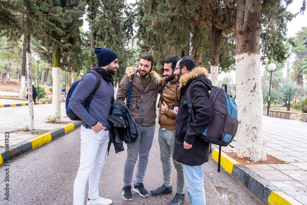 Happy arabic muslim friends enjoying life at university Happy arabic muslim friends enjoying life at university