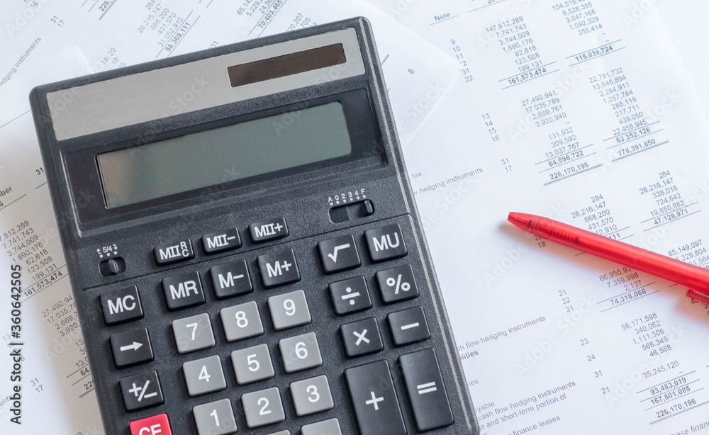 Accounting business concept. Calculator with financial statements and financial statements on the table. Accounting business concept. Calculator with financial statements and financial statements on the table.