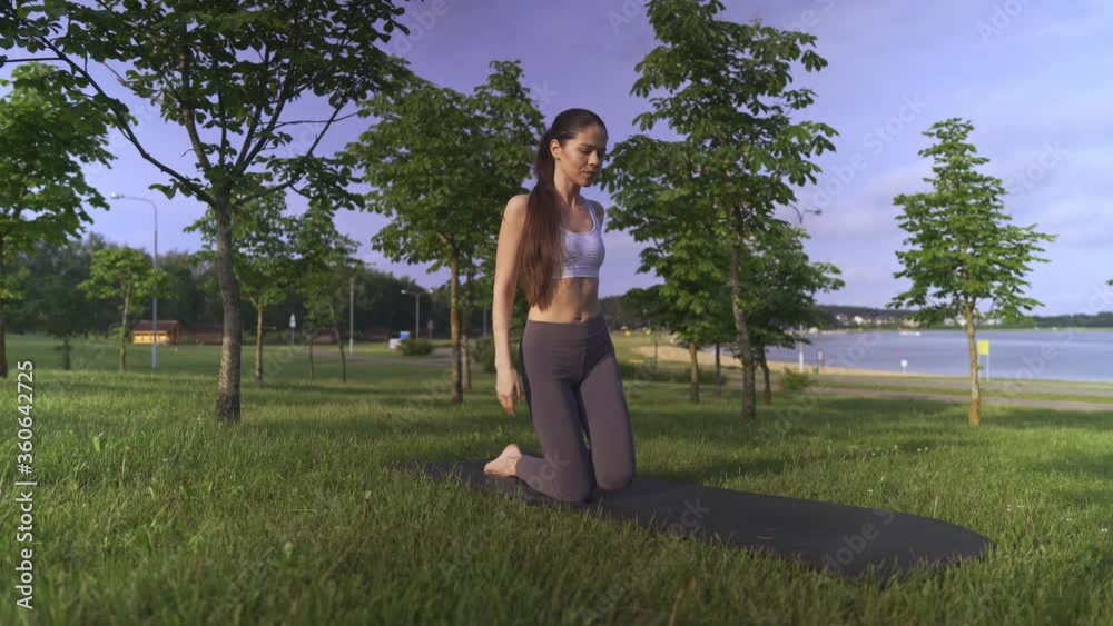Young woman yoga outdoors keep calm and meditates while practicing yoga to explore the inner peace. Young woman yoga outdoors keep calm and meditates while practicing yoga to explore the inner peace.