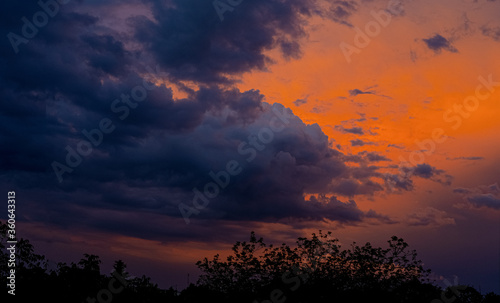 Clouds under a crimson sky at sunset