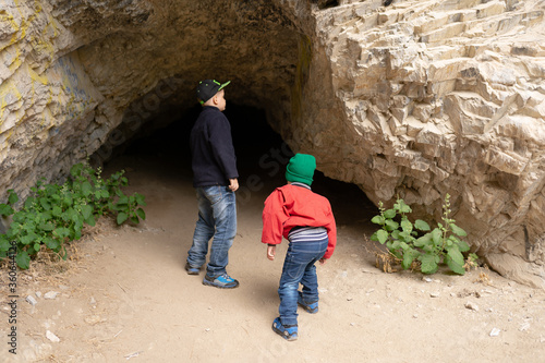 Children explore the entrance to the cave