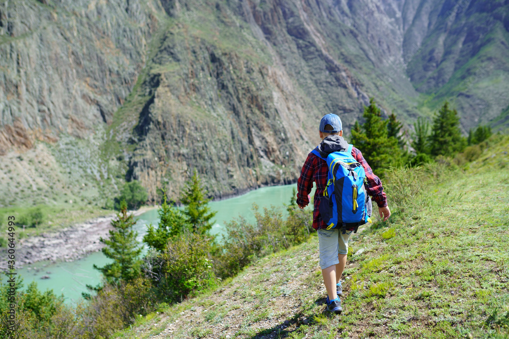 Fototapeta premium little hiker in the mountains
