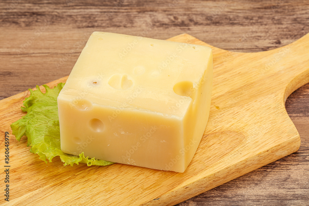 Emmental cheese over wooden board