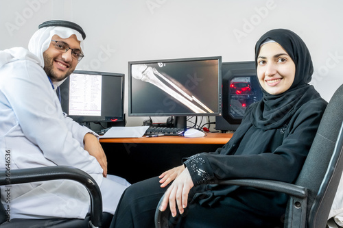 Arabic muslim doctor and his patient discussing x-ray photo