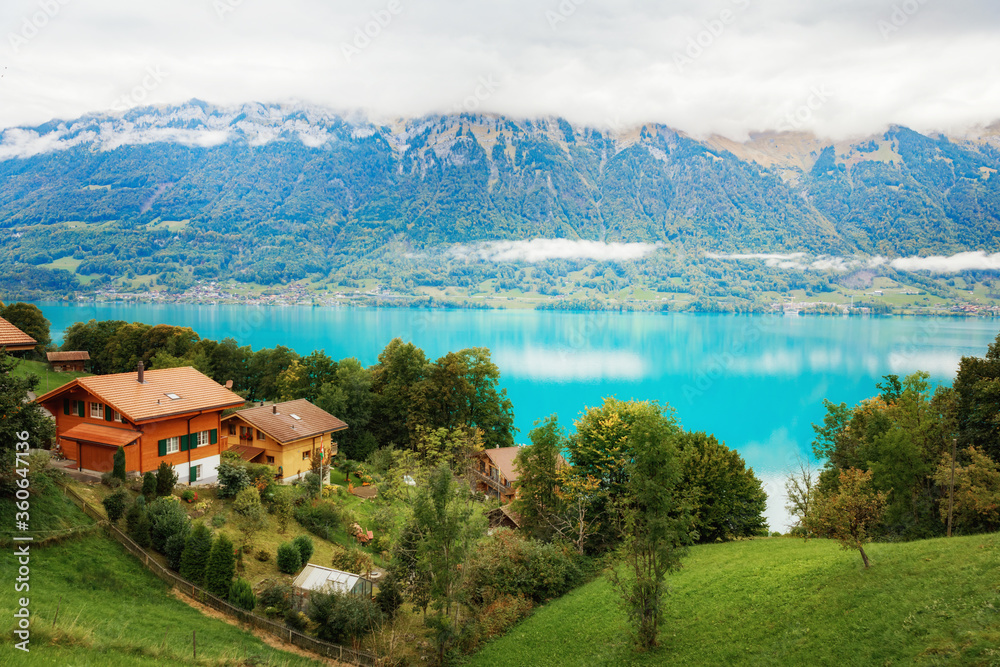 Amazing seasonal autumnal view of Brienzersee lake in Interlaken town, Switzerland. Panorama of Alpine lake with turquoise water.
