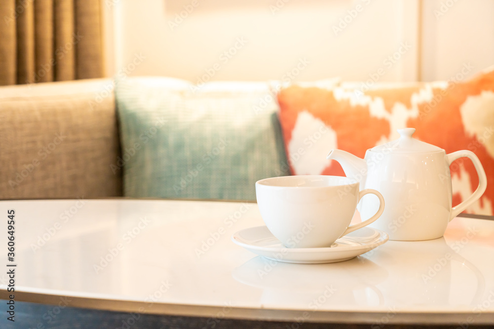 tea cup with teapot on table tea cup with teapot on table
