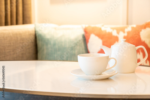 tea cup with teapot on table
