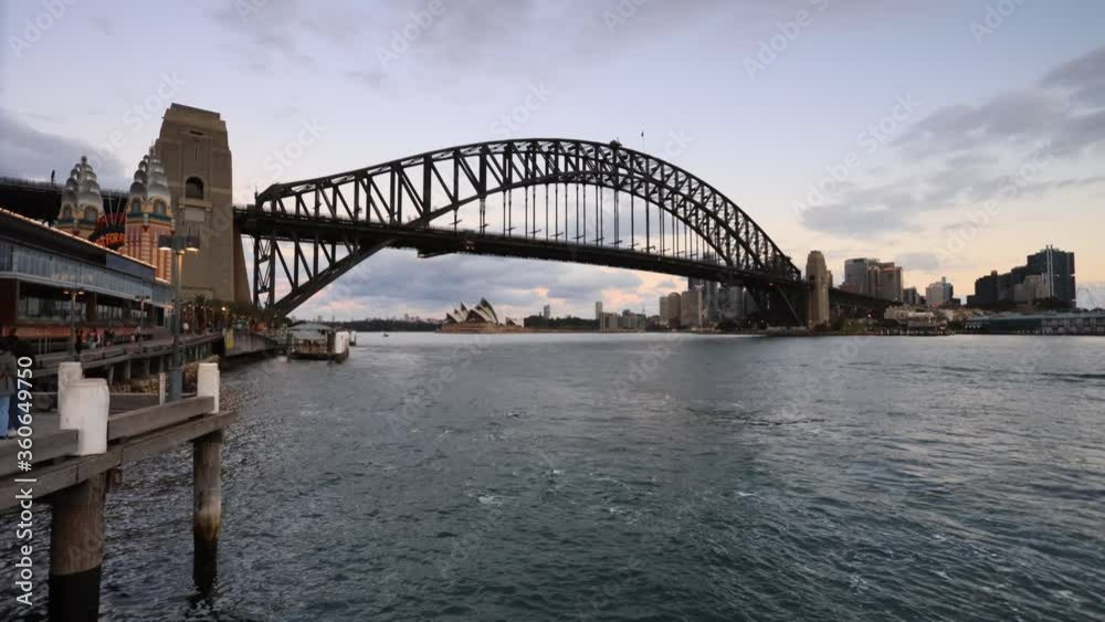 Timelapse of the Sydney Harbour bridge at sunset with bright lights and fast motion ferries.
Timelapse of the Sydney Harbour bridge at sunset with bright lights and fast motion ferries.