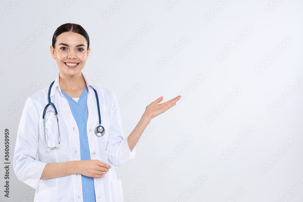 Portrait of young doctor with stethoscope on white background Portrait of young doctor with stethoscope on white background