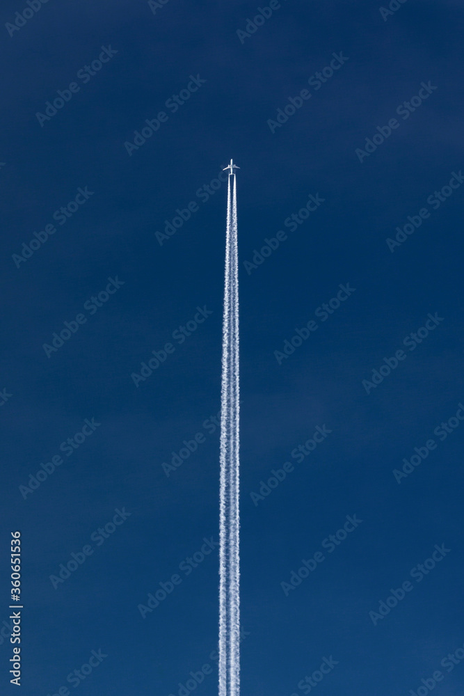 flight of an airplane at a height against a blue sky flight of an airplane at a height against a blue sky
