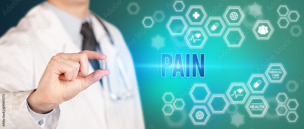 Close-up of a doctor giving you a pill with PAIN inscription, medical concept Close-up of a doctor giving you a pill with PAIN inscription, medical concept