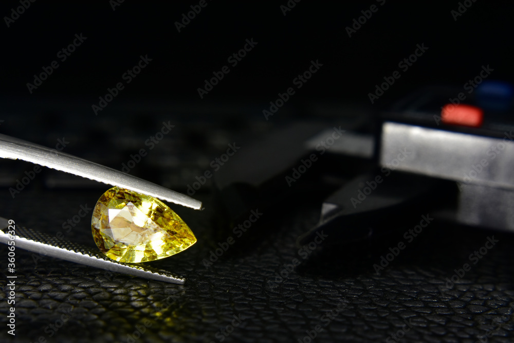 Yellow gem The heart shape is in the gemstone tong. Stock Photo | Adobe  Stock