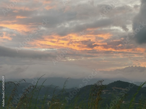 Early sunrise with thick clouds over the mountains.