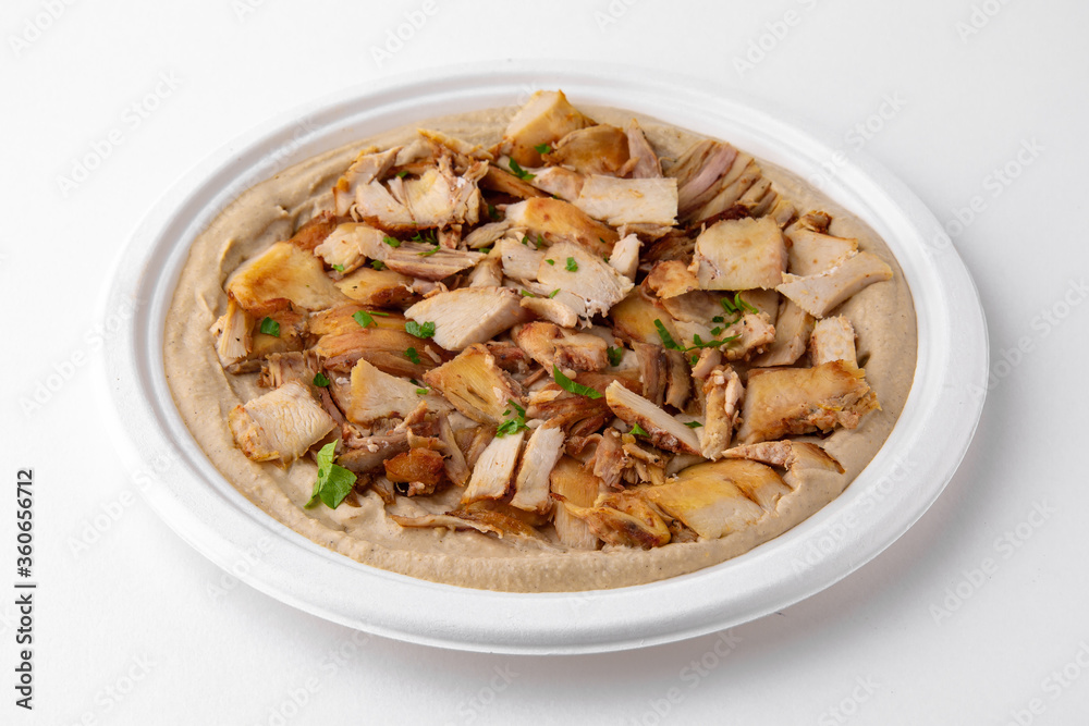 Hummus with chicken. A dish of crushed chickpeas for delivery, or online store. Isolated on a white background. Hummus with chicken. A dish of crushed chickpeas for delivery, or online store. Isolated on a white background.