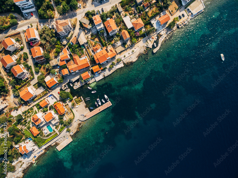 Aerial drone photo, top view - villas, houses and hotels on the beach in Montenegro, the Adriatic Sea.