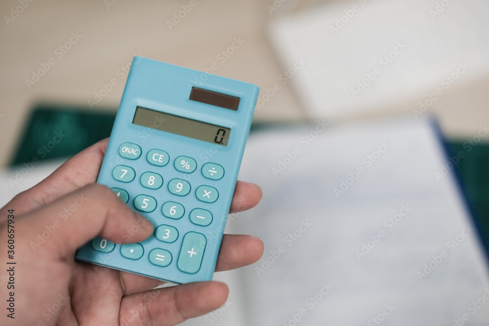 Accountants use the blue calculator to calculate company revenue Accountants use the blue calculator to calculate company revenue