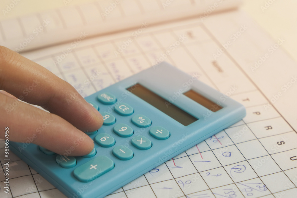 Accountants use the blue calculator to calculate company revenue Accountants use the blue calculator to calculate company revenue
