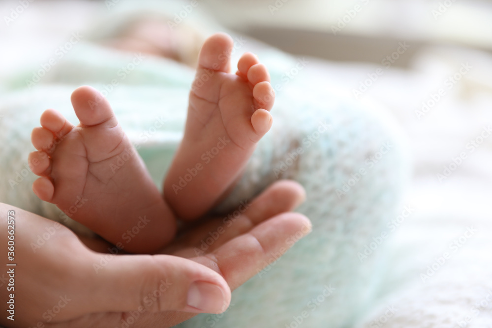 Mother and her newborn baby on white plaid, closeup Mother and her newborn baby on white plaid, closeup
