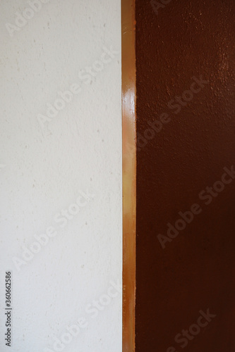 White wall with gold painted door frame