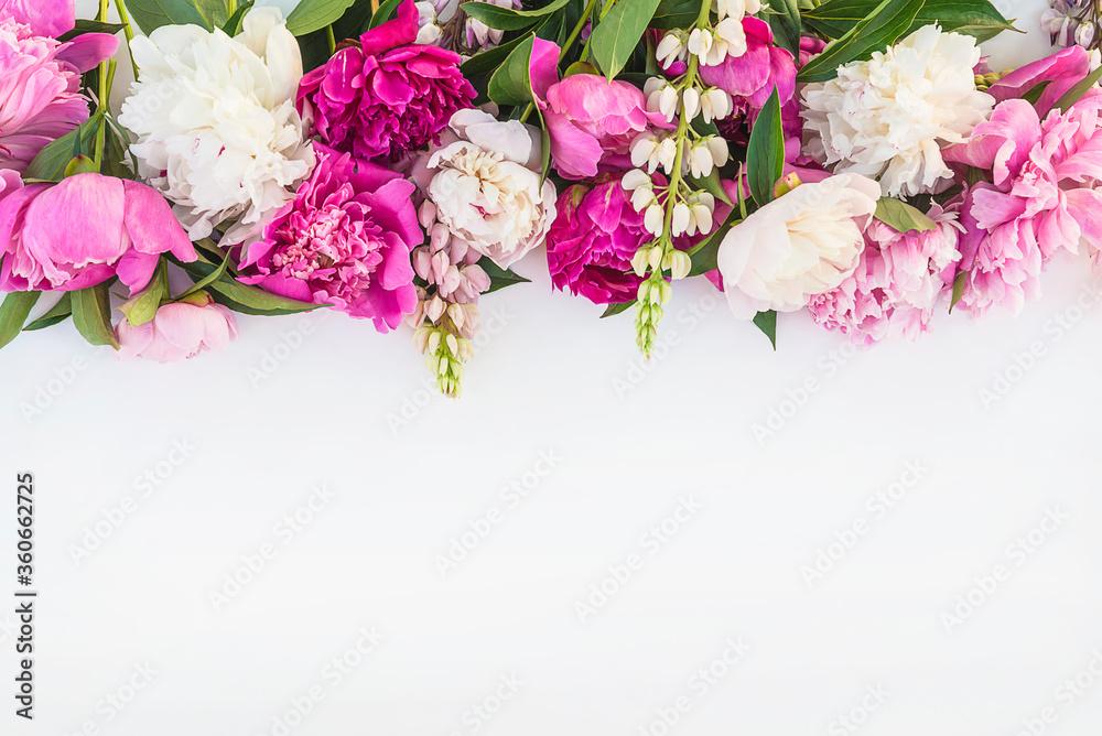 Beautiful floral frame of bunch of purple, pink, and white peonies on white background. Space for text, flat lay