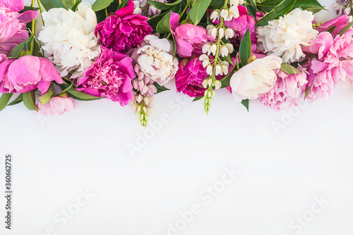 Beautiful floral frame of bunch of purple, pink, and white peonies on white background. Space for text, flat lay © stsvirkun