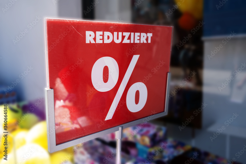 Red sales panel with percentage sign for reduced goods, in germany the MwSt (value added tax) is lowered during the coronavirus pandemic 2020, selected focus
