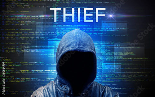 Faceless hacker with THIEF inscription on a binary code background