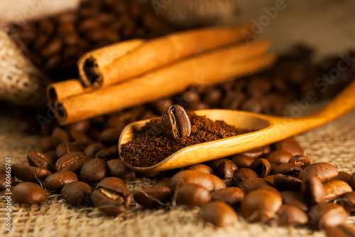 Coffee on wooden spoon on a burlap textured background