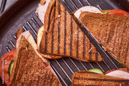 Homemade sandwiches lie on the groa grill photo