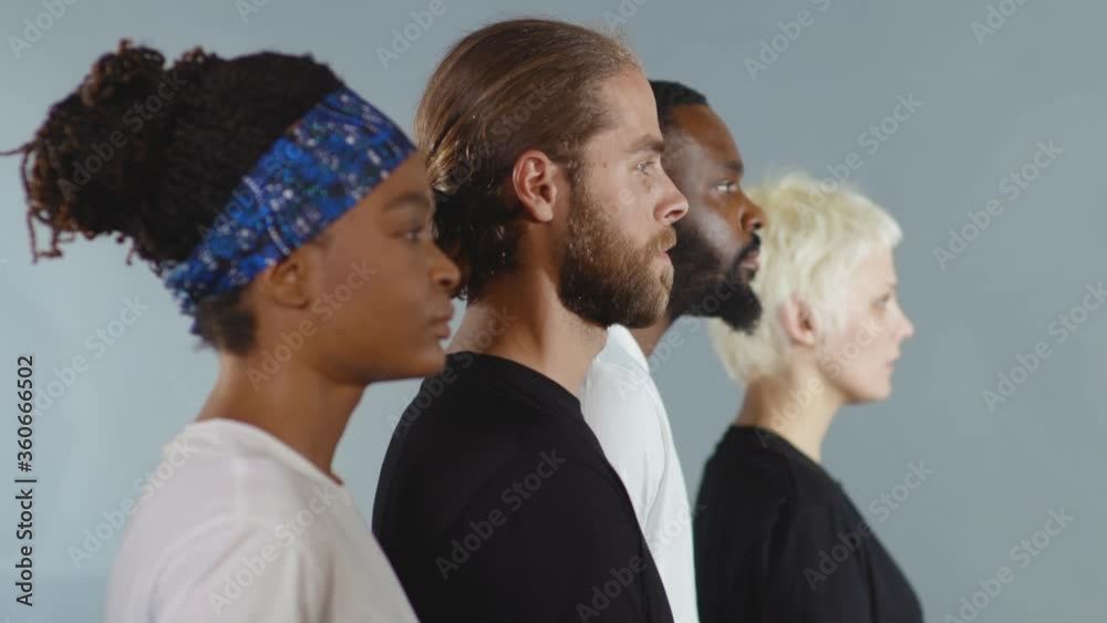 Side shot of group of people of different races raise head black white ...
