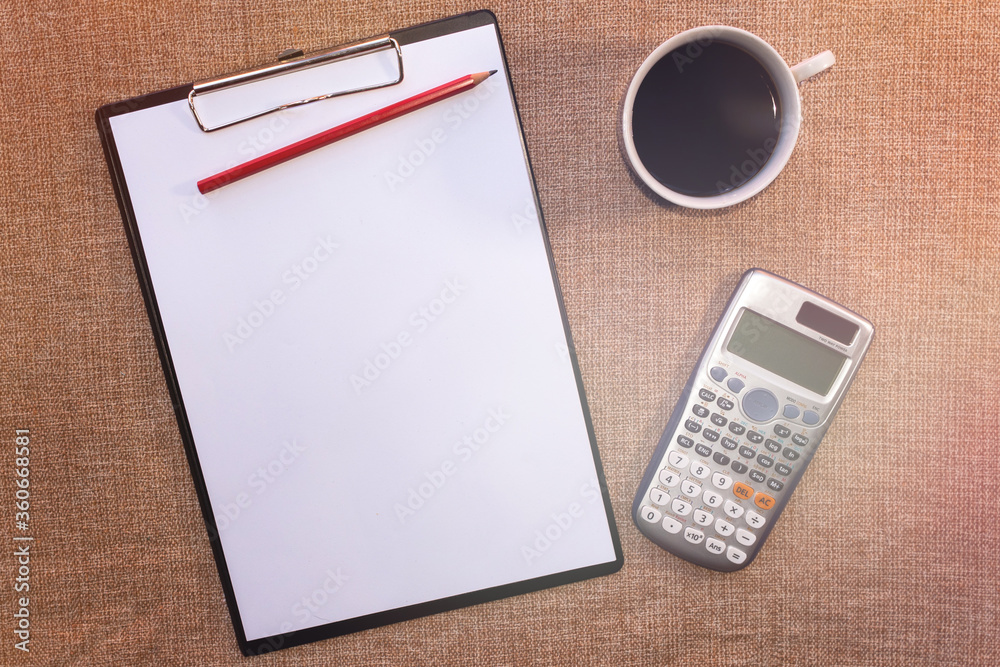 Flat desk, top view office table. Workspace with blank clip board, keyboard, office supplies, pencil, metal pen, reading glasses, cup of coffee on brown
background. Flat desk, top view office table. Workspace with blank clip board, keyboard, office supplies, pencil, metal pen, reading glasses, cup of coffee on brown
background.