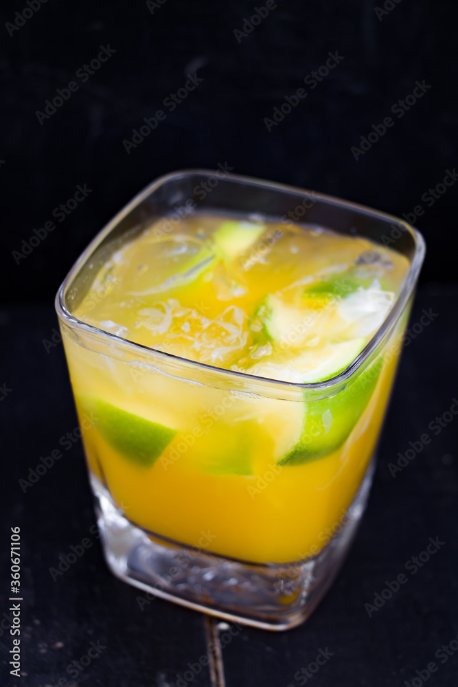 cocktail with lime, orange juice and ice. cocktail with lime, orange juice and ice.