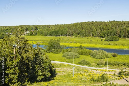 Top view of amazing nature landscape. Small river along asphalt road. Sweden. Europa. 